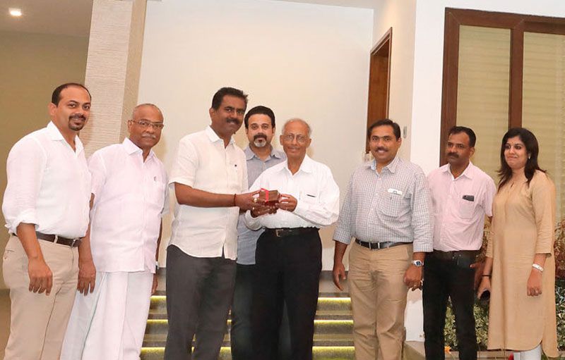 Sunil Kumar V., MD, hands over the key to the first completed villa of the Super Luxury Private Villa Project, Asset Insignia, to Dr. George Varkey Thalody.